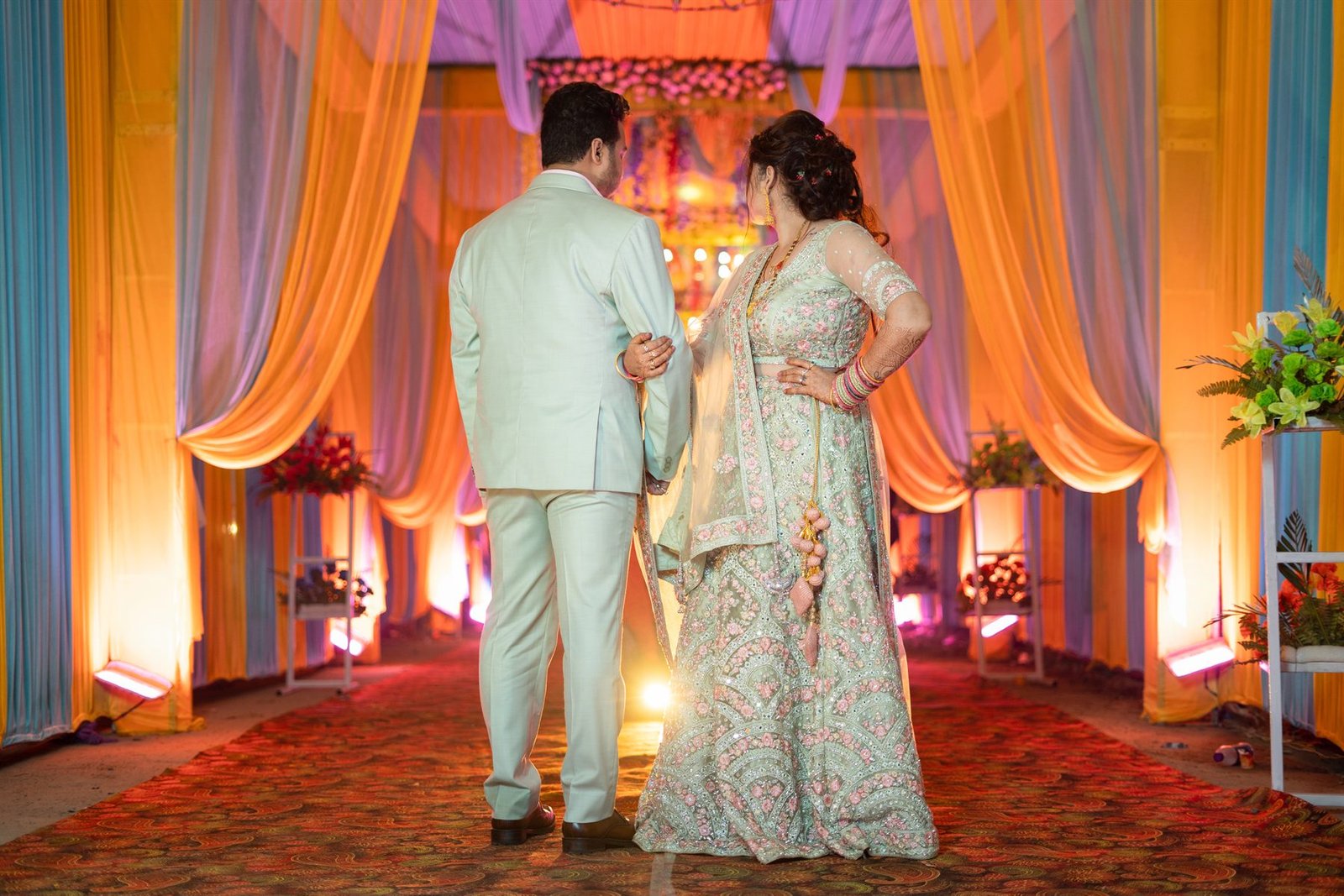 Engagement couple against colourful decor